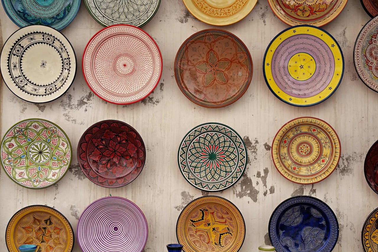 A vibrant collection of traditional Moroccan ceramic plates showcasing intricate designs and colors.